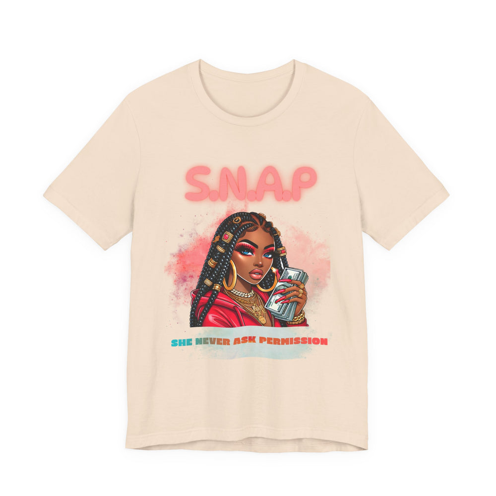 Beige t-shirt with a graphic of a woman holding a phone and the text 'SNAP SHE NEVER ASK PERMISSION' on a white background.