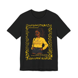 Black t-shirt with a graphic of a woman in a yellow shirt and sunglasses, framed by yellow text on a white background.