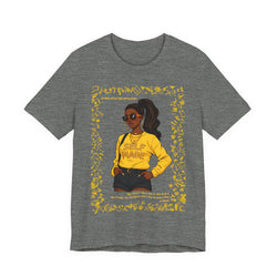 Gray t-shirt with a graphic of a woman in a yellow shirt and sunglasses, surrounded by yellow flowers on a white background.