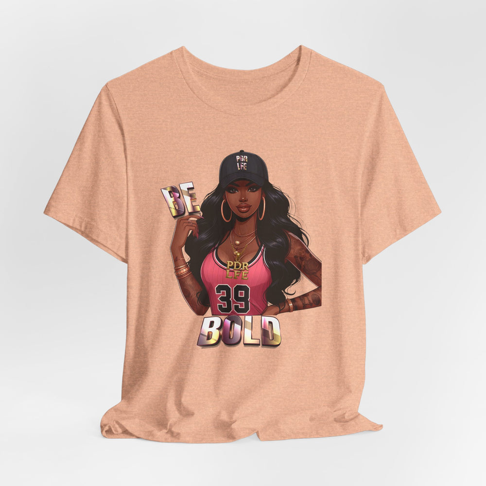 Heather Peach t-shirt with a graphic of a woman and 'Be Bold' text on a light gray background