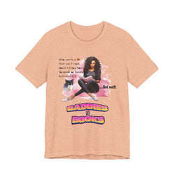 Peach t-shirt with graphic design featuring a woman, cat, and text on a white background