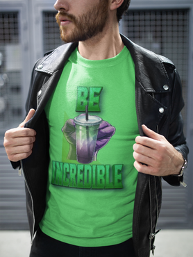 Person wearing a green t-shirt with a graphic design and text, standing against a blurred background.