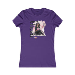 Purple t-shirt with graphic design of a woman reading a book, surrounded by balloons and text on a white background.