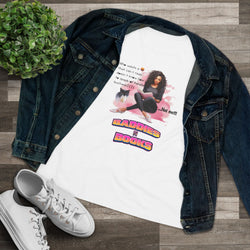 White T-shirt with graphic design and text, paired with a denim jacket and white sneakers on a wooden surface.