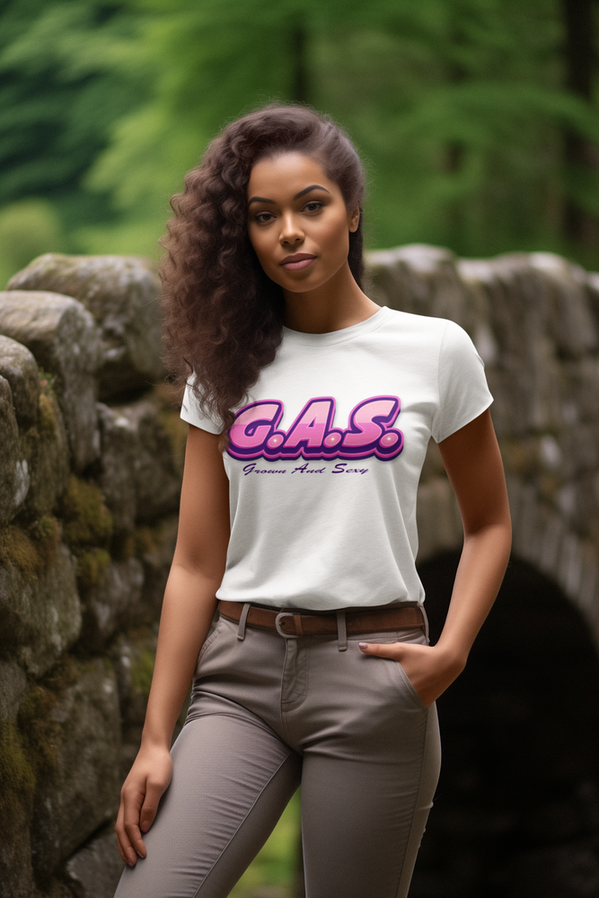Woman wearing a white t-shirt with 'G.A.S.' text in a forest setting