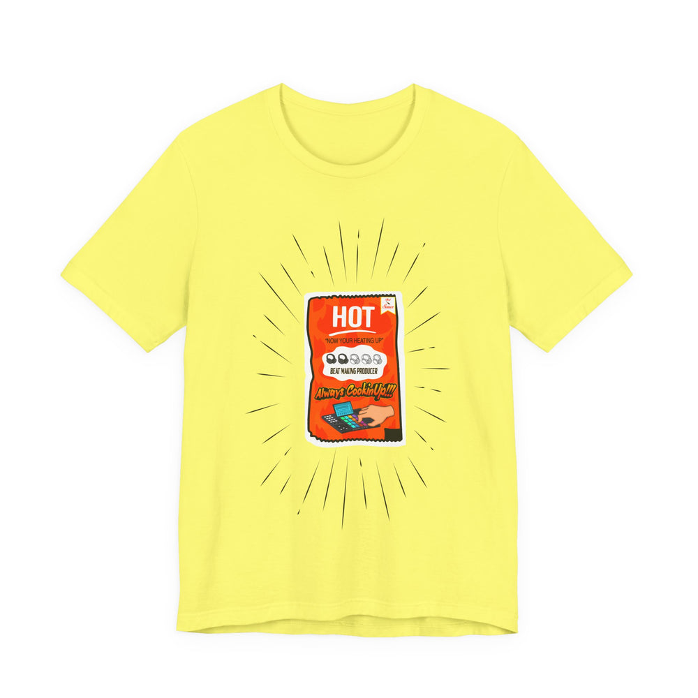 Yellow t-shirt with a graphic of a hot sauce packet on a white background